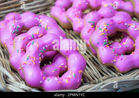 Sweet pink glazed donuts in a basket Stock Photo