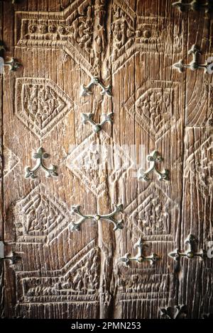 Fragment of old carving wooden door. Close-up Stock Photo