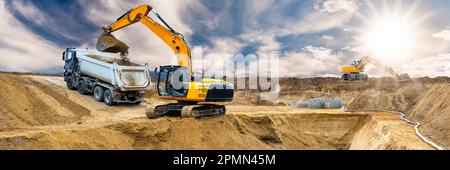excavator ist digging and working at construction site Stock Photo