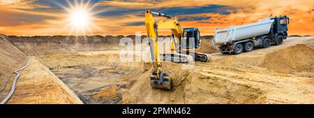 excavator ist digging and working at construction site Stock Photo