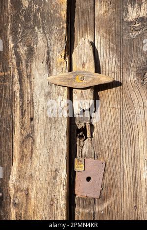 detail of the traditional closing of an old, traditional wooden door without painting Stock Photo