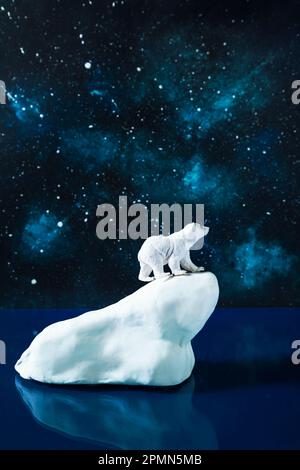 Polar bear on an ice floe in the cold northern sea. Starry arctic night. Installation. Stock Photo