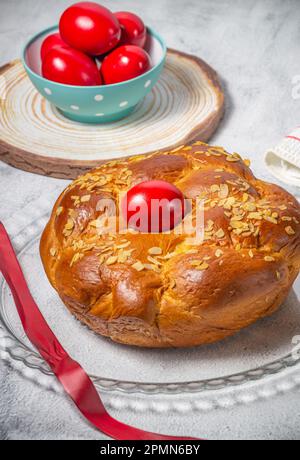 Easter traditional bread, greek tsoureki and red eggs on a table Stock Photo