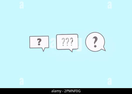 Speech bubbles with question marks on blue background Stock Photo
