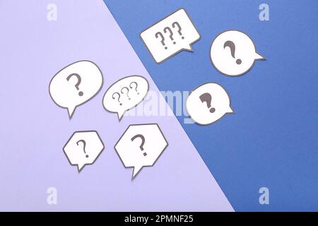Speech bubbles with question marks on color background Stock Photo