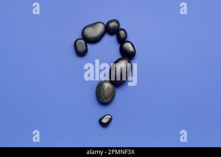 Question mark made of spa stones on blue background Stock Photo
