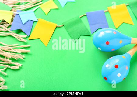 Frame made of Mexican maracas, flags and serape on green background, closeup Stock Photo