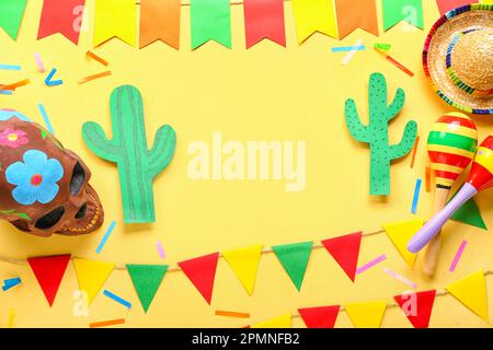 Frame made of Mexican symbols with flags on yellow background Stock Photo