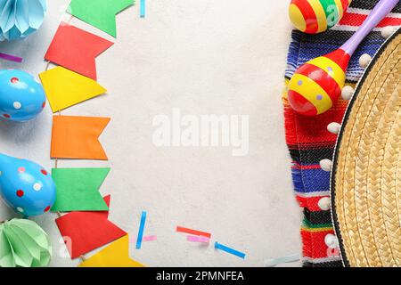 Frame made of Mexican maracas with flags and confetti on white background Stock Photo