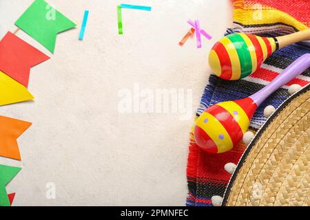 Frame made of Mexican maracas with flags and confetti on white background Stock Photo