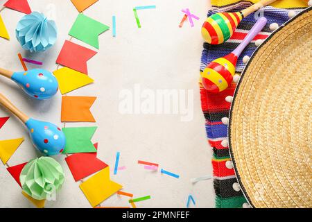 Frame made of Mexican maracas with flags and confetti on white background Stock Photo