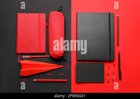 Composition with, notebooks stationery supplies and paper plane on color background Stock Photo