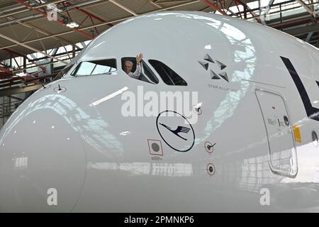 Lufthansa Airbus A380 long-haul aircraft will land again for the first time in Munich at Franz Josef Strauss Airport on April 12, 2023. A380 after landing in the Lufthansa Technik hangar. Pilot Raimund Mueller waves from the open cockpit window. ? Stock Photo