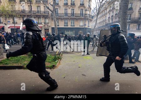 Paris, France. 13th Apr, 2023. Police officers seen dispersing protesters during the clashes. New wave of protests on the 12th day of the general strike over the Macron government's new pension reform, before crucial court decision on the legislation of the Constitutional Council. Credit: SOPA Images Limited/Alamy Live News Stock Photo