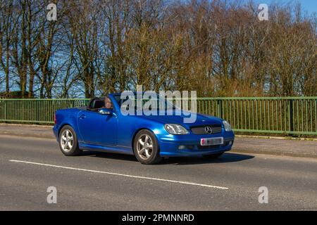 2001 Blue Mercedes Benz SLK 320  3199cc Petrol 5 speed automatic cabrio; crossing motorway bridge in Greater Manchester, UK Stock Photo