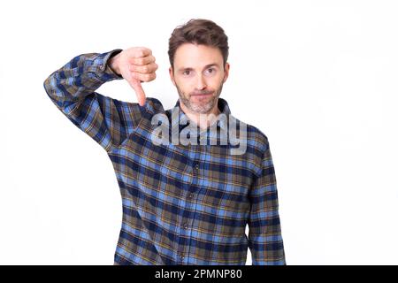 Adult hipster male model posing with thumb down. Stock Photo