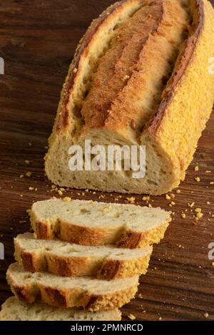Slices of homemade fresh baked loaf of corn bread on a cutting board close up Stock Photo