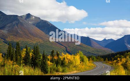 Beautiful Fall colors and mountain views along the Richardson Highway with the Little Tonsina River flowing nearby; Alaska, United States of America Stock Photo
