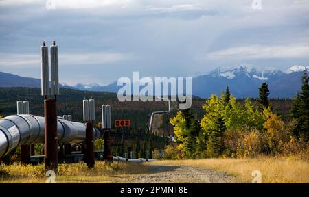 Scenic view of the Trans-Alaska Pipeline in autumn with rain clouds over the mountains in the distance. This is the crude oil pipeline that spans A... Stock Photo