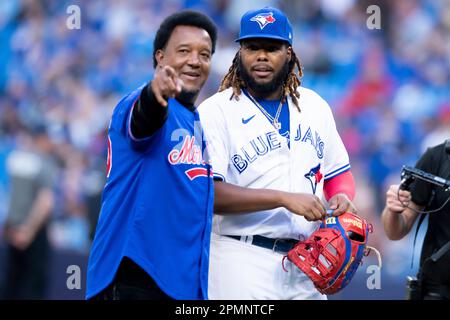 TORONTO, ON - APRIL 12: Legendary Montreal Expos pitcher Pedro Martínez  (45) shakes hands with Toronto Blue Jays First base Vladimir Guerrero Jr.  (27) before the MLB baseball regular season game between