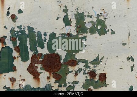 Flaking peeling paint on rusty metal surface. Abstract worn background with copyspace. Stock Photo