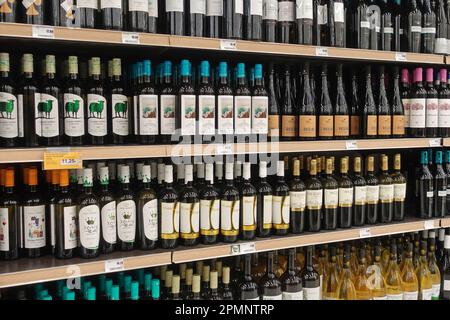 Athens, Greece - March 6, 2023: Red and white wine alcohol beverage bottles on liquor store shelves. Stock Photo