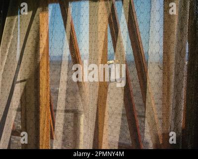 Hotel window and lacy curtains; Namib-Naukluft Park, Sossusvlei, Namibia Stock Photo