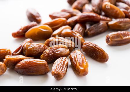 Fresh dried dates fruit on white isolated background. Stock Photo