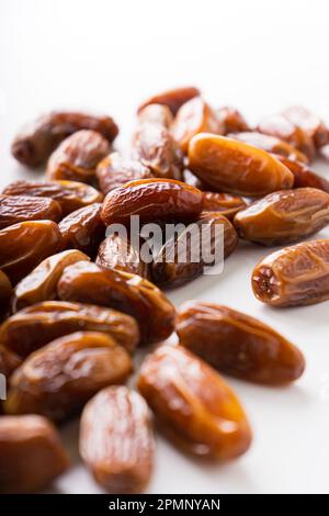 Fresh dried dates fruit on white isolated background. Stock Photo