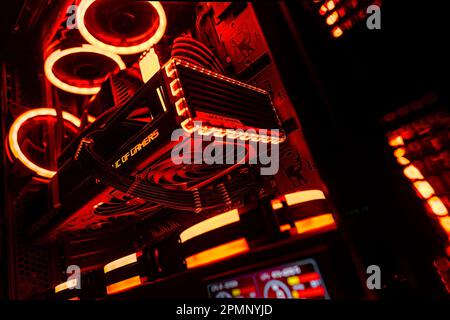 Milan, Italy 14 april 2023: Show off your setup with this stunning image of a gaming PC featuring an illuminated interior and advanced tech components Stock Photo