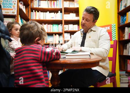 Jamie Oliver signs books at his local independent bookshop, Harts in Saffron Walden, Essex, to promote his new book Billy and the Giant Adventure. Picture date: Friday April 14, 2023. Stock Photo