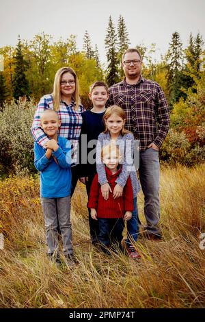 Portrait of a family of six in a park in autumn; Edmonton, Alberta, Canada Stock Photo
