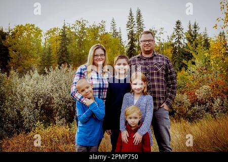 Portrait of a family of six in a park in autumn; Edmonton, Alberta, Canada Stock Photo
