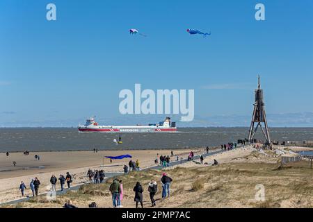 People, flying kites, freight ship, sea marker Kugelbake, North Sea, Elbe, Cuxhaven, Lower-Saxony, Germany Stock Photo