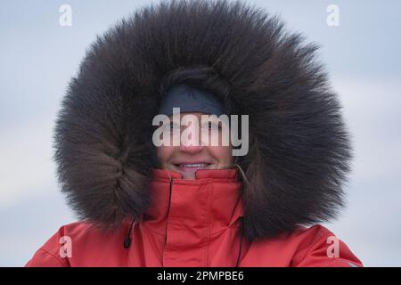 Woman dressed in a large winter parka in the extreme cold; Churchill, Manitoba, Canada Stock Photo