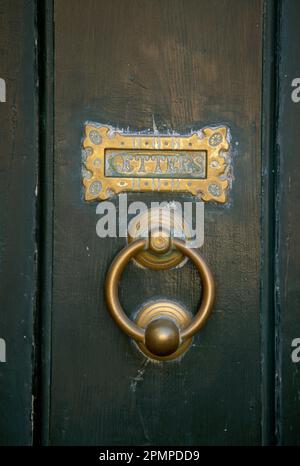 Close view of an old door knocker and mail slot on a wooden door; Newport, Rhode Island, United States of America Stock Photo