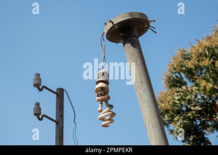 A broken street light against a blue sky in Luxor, Egypt Stock Photo