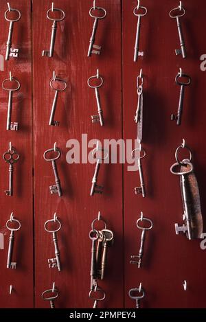 Vintage skeleton keys hanging on hooks; Massachusetts, United States of America Stock Photo