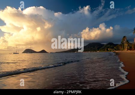 From coconut beach, one of the only sandy beaches on the island, one can see a dramatic cloud formation hanging over hilly Portsmouth, which extend... Stock Photo