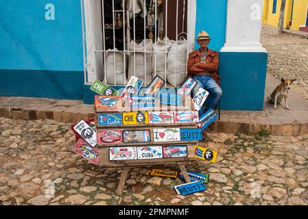 Vendor sells license plates on a street in Trinidad, Cuba; Trinidad, Cuba Stock Photo