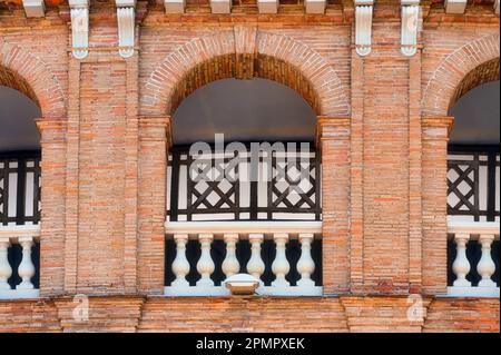 Valencia, Spain - March 17, 2023: Balcony and arched window in the colonial bullring building Stock Photo