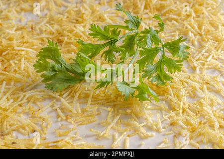 Chilled salty chicken pie, typical Brazilian dish. In a golden shape, gray wooden background and coriander detail on the pie. Close view. Stock Photo