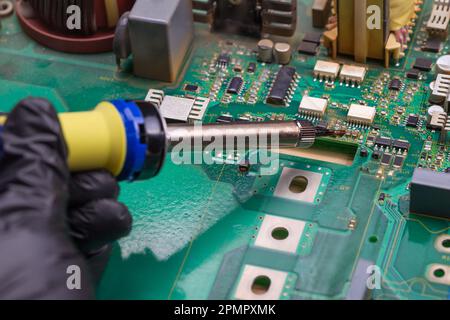 Soldering iron. Repairing electronic component. Microelectronics engineering concept Stock Photo