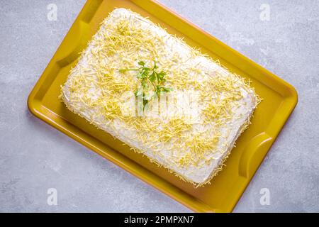 Chilled salty chicken pie, typical Brazilian dish. In a golden shape, gray wooden background and coriander detail on the pie. Top view. Stock Photo