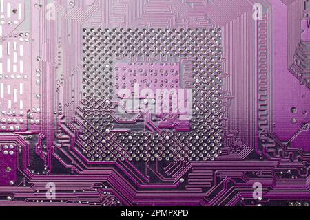 Circuit board background. Close up of a printed purple computer circuit board Stock Photo