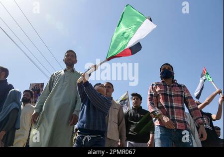 Srinagar, India. 14th Apr, 2023. A Muslim Kid waves a Palestinian Flag during a rally marking Quds (Palestine) day in Srinagar. (Al-Qud) is the Arabic name For Jerusalem. An initiative started by the late Iranian revolutionary leader Ayatollah Ruhollah Khomeini, Al Quds Day is celebrated globally on the last Friday of the Holy month of Ramadan to show support for Palestinians and condemn Israel. Credit: SOPA Images Limited/Alamy Live News Stock Photo