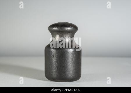 Old cast iron weight for weighing on a scale. Stock Photo