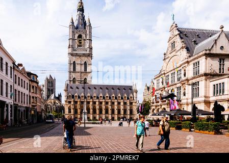 Sint-Baafsplein, the heart of the city. Three powers are represented in this central square: the citizenry by its mighty Belfry (C), the intellect by Stock Photo