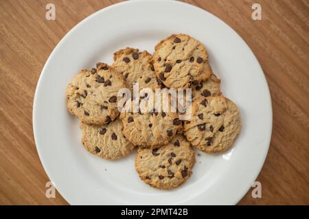 details of delicious cookies decorated with chocolate chips, pastry in studio, food and dessert texture Stock Photo