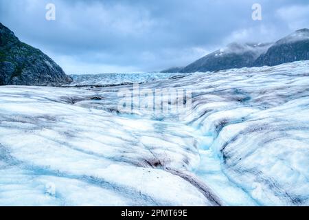 Melting glacier ice in the Mendenhall Glacier in Alaska forms a winding stream of crystal clear blue water Stock Photo